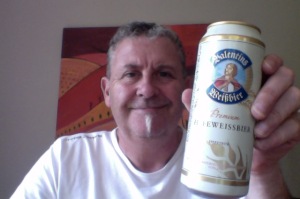 white haired man has a wheat beer 